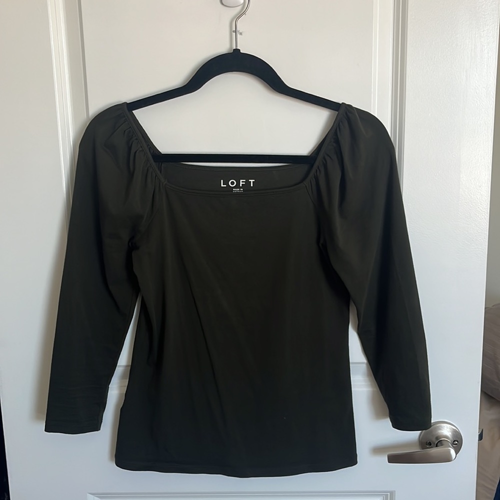 Flattering 3/4 sleeve top in moss green. Comfortable, easy to tuck into bottoms.